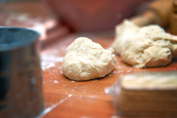 Piece of unleavened yeast-free dough for making dumplings lying on table