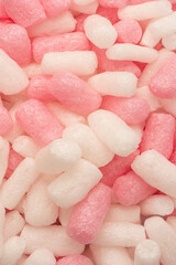 Pink and white box filler as a background. Top view.