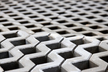 Checkered Concrete Cinder Tiles Of A Garden Sidewalk Lawn In Palette. Turf Grass Block Paving Stones. Grasscrete is eco friendly material for driveways, parking lots or garages instead of concrete