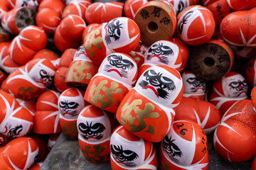 Daruma dolls display at a market during festival in Japan with vibrant colors and intricate designs on each figure