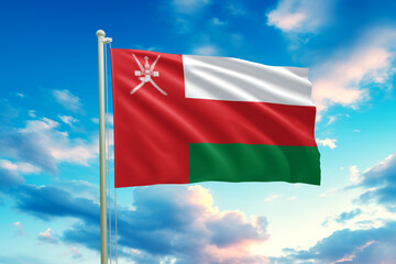 The Oman flag waves gracefully against a bright sky, showcasing its red, white, and green stripes with the national emblem. Clear lighting, crisp fabric motion, and a clean, uplifting atmosphere.
