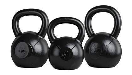 Three black kettlebells of varying weights stand together, emphasizing fitness and strength training in a stark studio setting