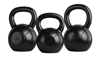 Three black kettlebells of varying weights stand together, emphasizing fitness and strength training in a stark studio setting