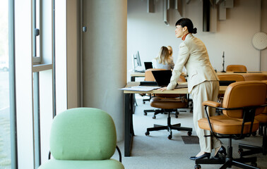 Professional woman in an office reflecting during a busy workday