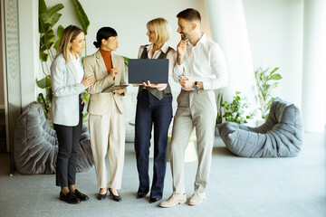 Business team collaborates in modern office space during daytime meeting