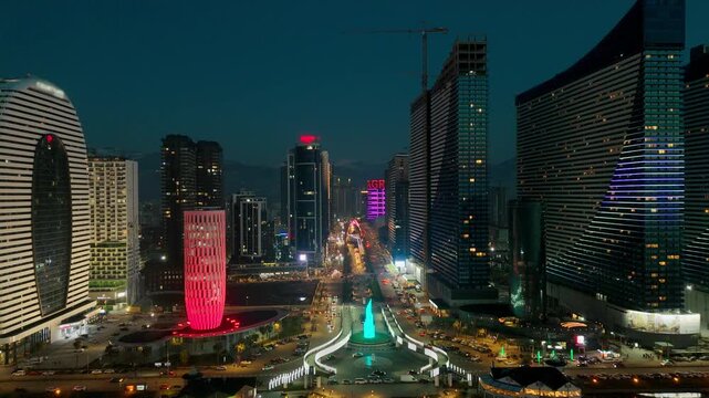 Cityscape of Batumi with skyscrapers with night illuminated, Aerial video