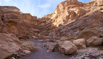 Unique landscape in Eilat Mountains nature reserve, southern Negev, as seen in Israel Trail that passes through the reserve. Boulders in a hiking trail. Weekend in the nature with whole family.