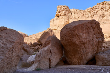 Unique landscape in Eilat Mountains nature reserve, southern Negev, as seen in Israel Trail that passes through the reserve. Huge boulders in a hiking trail. Weekend in the nature with whole family.
