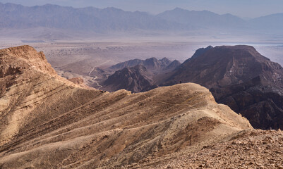 Unique landscape in Eilat Mountains nature reserve, the southern Negev, as seen from the Israel Trail passes through the reserve. A group of hikers resting in a mountain ridge. Active lifestyle.