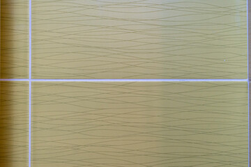 Textured background featuring yellow tiles with subtle wavy patterns. Ideal for design projects, home decor, or construction themes. Captivating and versatile backdrop.