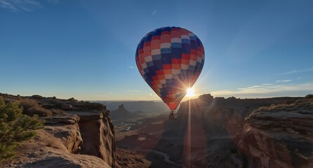 Obraz premium colorful hot air balloon soaring over canyonlands national park at sunrise with dramatic light rays.