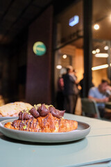 Chocolate topped croissant served on a plate, showcasing artisanal bakery products, caf&eacute; lifestyle, and modern dessert presentation. Publique bakery, popular tourist destination in Melbourne