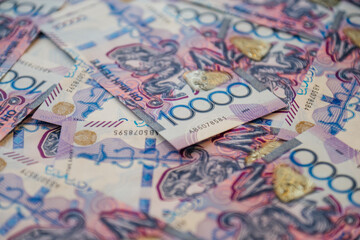 10,000-tenge banknotes are laid out on the table