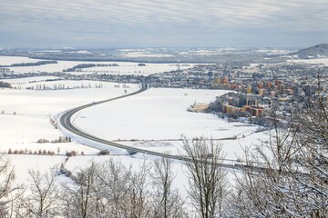 Stary Jicin castle ruins viewpoint. Snow-covered road bypass around Nova Jicin. Czech Republic.