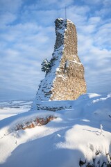 Stary Jicin castle ruins. Snow-covered dominant remnant of the wall in the upper courtyard. Czech Republic.