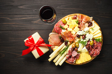 Antipasto platter with jamon, salami and cheese assortment with christmas decorations.