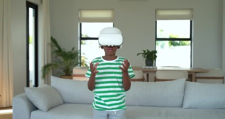 After VR headset activation, boy is tapping and twisting VR controls for gameplay in living room - Powered by Adobe