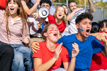 Fototapeta premium Diverse group of enthusiastic fans celebrating sport event. People showing excitement and support in stadium stands