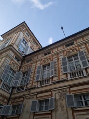 Fototapeta premium Historic Street in Borgo San Leonardo, Milan with Colorful Buildings and Clear Sky 