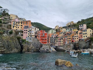 Riomaggiore - Village of Cinque Terre National Park at Coast of Italy. Beautiful colors at sunset. Province of La Spezia, Liguria, in the north of Italy - Travel destination and attractions in Europe.