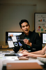 Business professional confidently presenting financial data charts on a tablet to colleagues, discussing market analysis and strategy