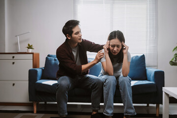 Asian man comforting partner struggling with stress, anxiety, or relationship problems, offering support during a difficult time
