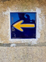 Arrow painted in yellow. Sign of the Camino de Santiago. Way of saint James
