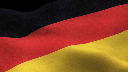 Naklejka premium German flag fluttering in the wind isolated on black background
