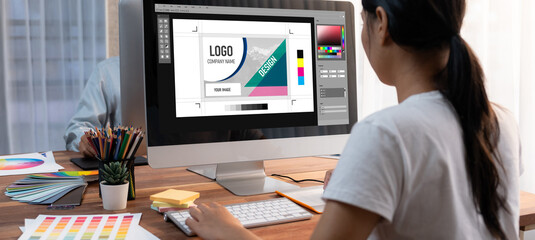 Graphic designer software for modern design of web page and commercial brisk ads showing on the computer screen