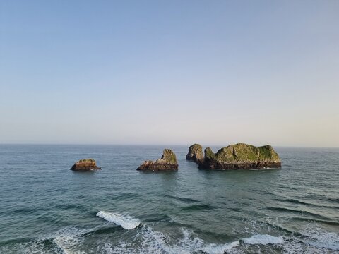 View on Playa de Palombina in Celorio village, Green coast of Asturias, North Spain with sandy beaches, cliffs, hidden caves, green fields, forests and mountains.
