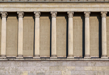 Naklejka premium Columns and wall of an old building as an abstract background, architectural details