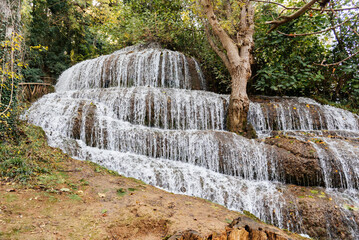 Scenic waterfall cascading over layered rock formations in Monasterio de Piedra