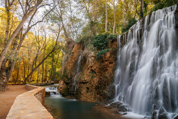 Scenic waterfall cascading into a tranquil pool at Monasterio de Piedra, Spain