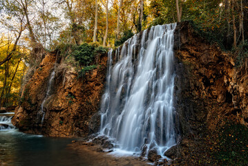 Scenic waterfall cascading down rocks in Monasterio de Piedra, Spain