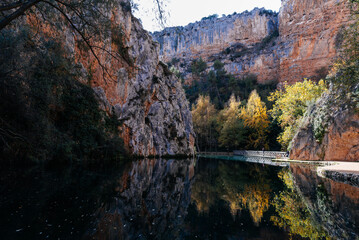 Monasterio de Piedra canyon lake reflecting autumn foliage in Zaragoza, Spain