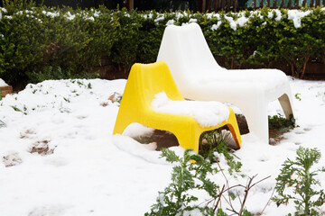 Bright Garden Chairs Covered in Winter Snow