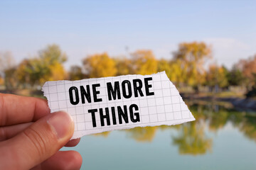 One More Thing message written on ripped torn paper background. Conceptual One More Thing symbol. Copy space.