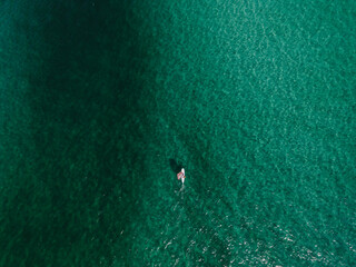 Aerial view of windsurfer on clear tropical water