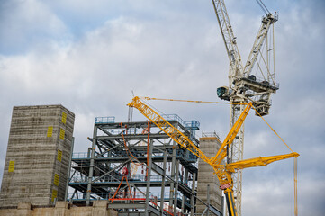 Tower cranes high in sky at construction site