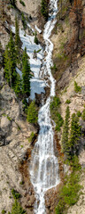 Long waterfall in a pano crop flows through a small canyon