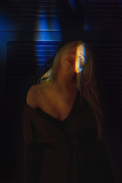 Woman in atmospheric light with rainbow glow