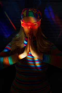 Woman exploring VR with headscarf in atmospheric lighting