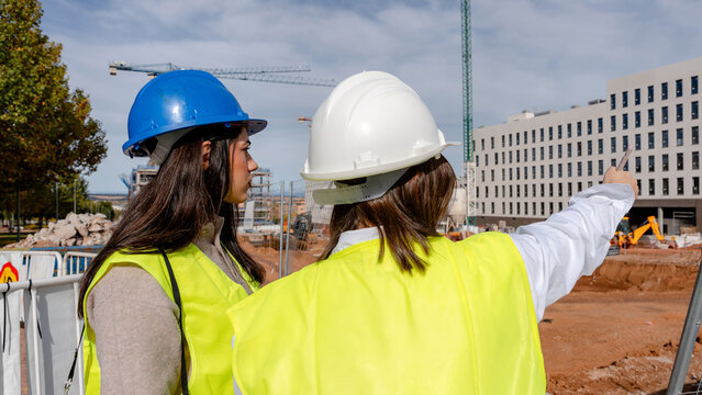 Architect and engineer discussing at a construction site