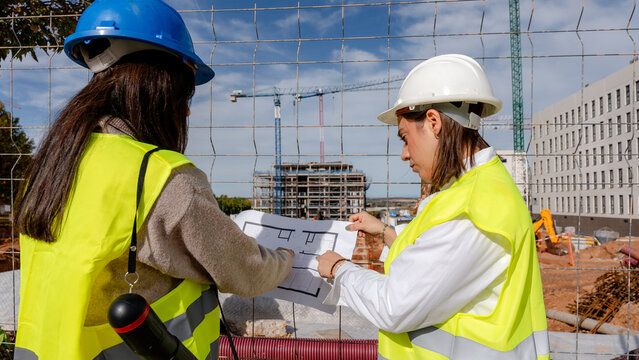 Architect and engineer collaborating on construction site