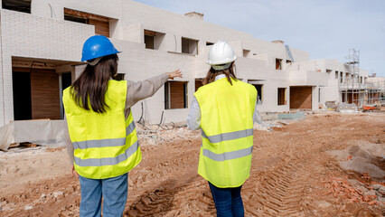 Architect and engineer inspecting construction site