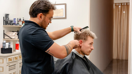 Barbershop stylist perfecting a modern haircut