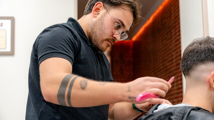 Barber giving a precise haircut in a modern barbershop