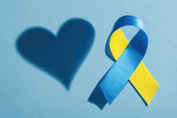 Blue and yellow awareness ribbon with heart shadow, down syndrome ribbon