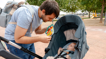 Father and baby bonding in a park