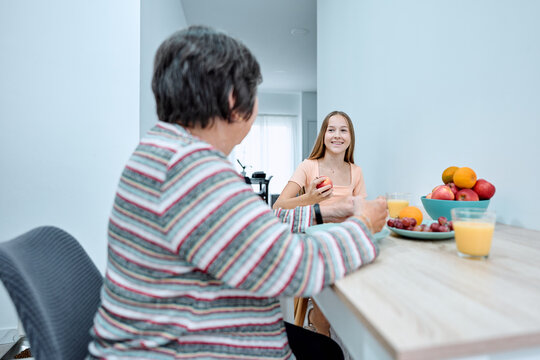 Teenager girl and grandmother bonding at home